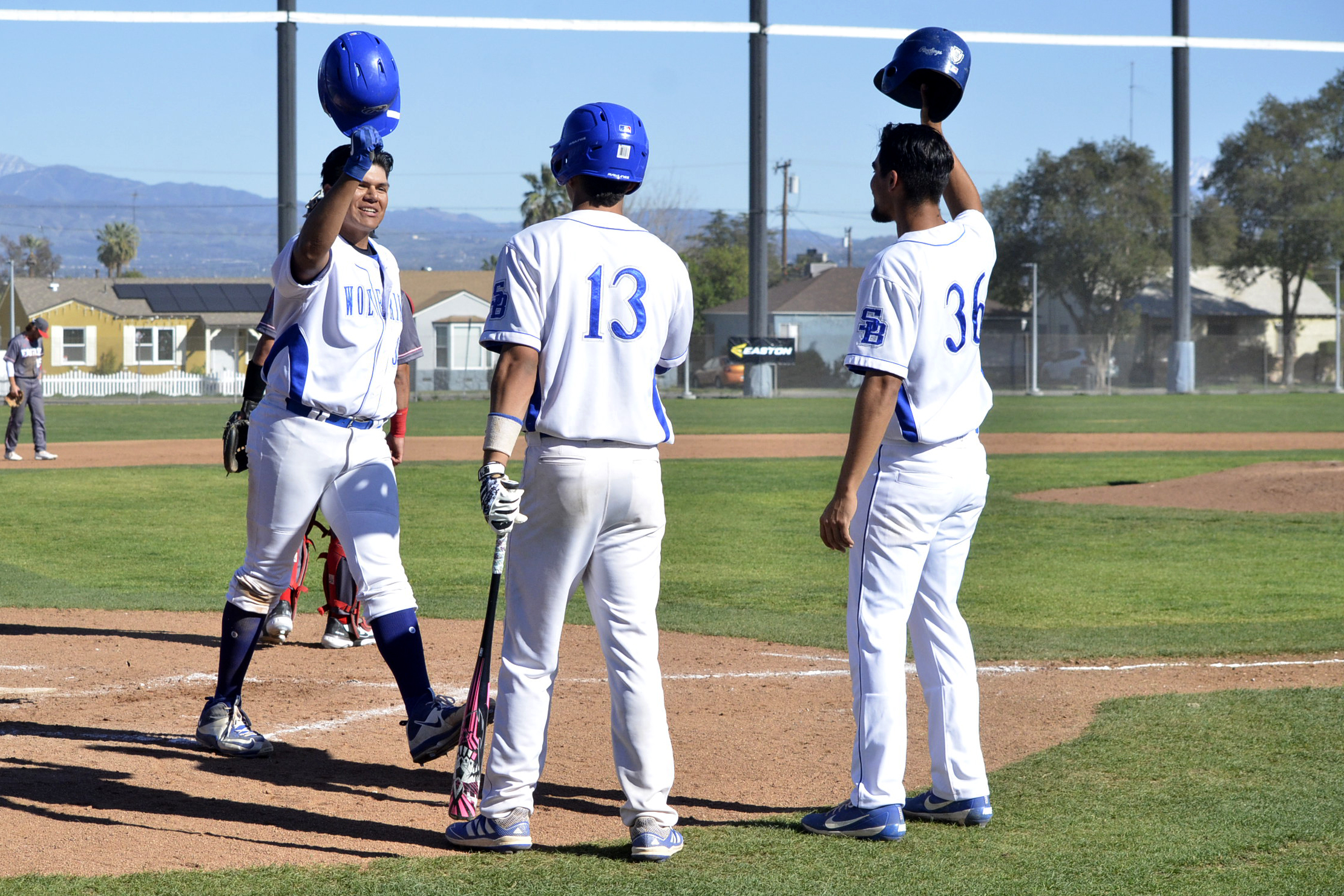 Guillermo Velasco is greeted at home plate after hitting a two-run home run Tuesday afternoon.